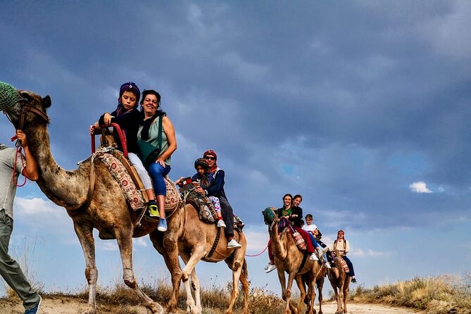 Cappadocia Camel Ride Tour - Getting on and staying steady: camels, mounting block, and handlers